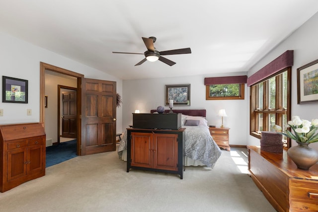 carpeted bedroom featuring ceiling fan and vaulted ceiling