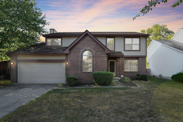 view of front property with a lawn and a garage