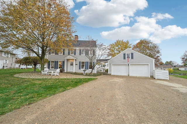 colonial home featuring a garage and a front yard