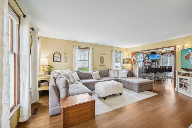 living room featuring hardwood / wood-style floors and ceiling fan