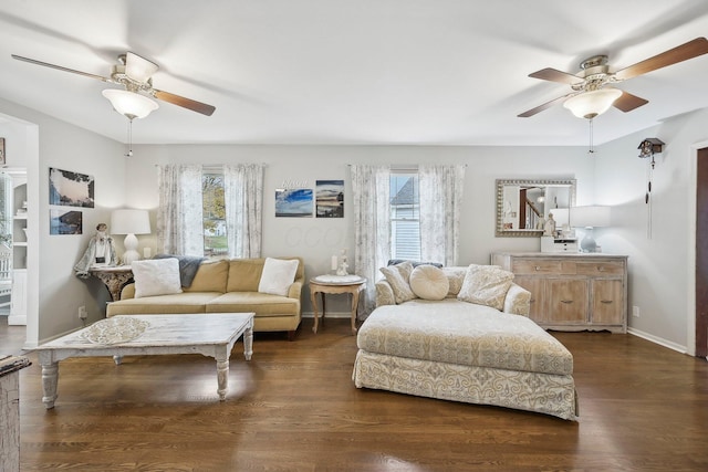 living room with dark wood-type flooring, ceiling fan, and a healthy amount of sunlight