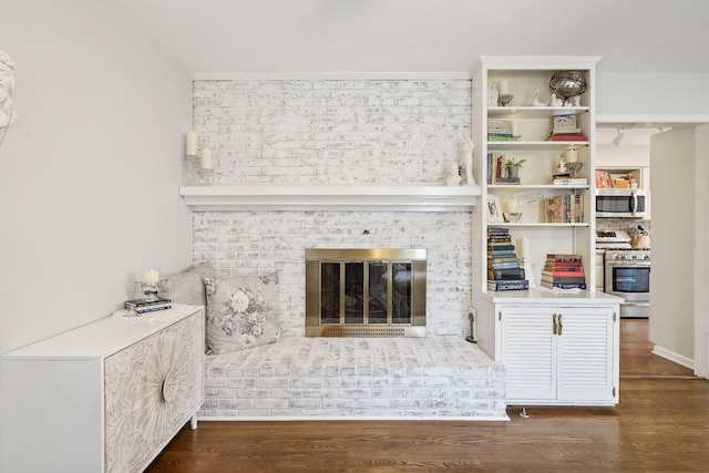 unfurnished living room with a fireplace and dark wood-type flooring