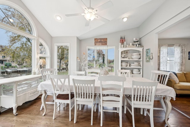 dining area with hardwood / wood-style flooring, ceiling fan, and lofted ceiling