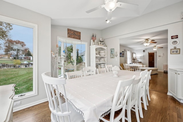 dining room featuring ceiling fan, plenty of natural light, dark wood-type flooring, and lofted ceiling