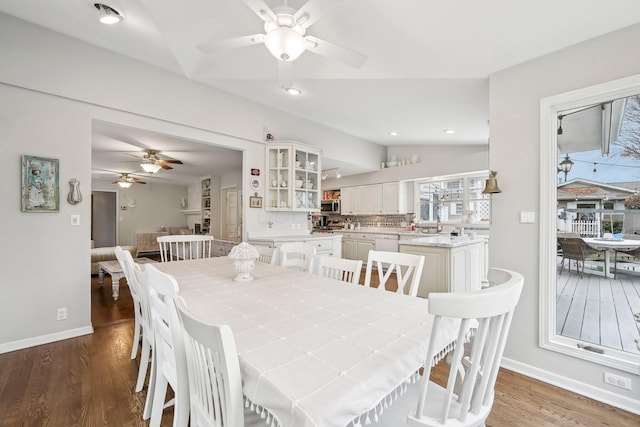 dining room featuring vaulted ceiling, ceiling fan, and dark hardwood / wood-style floors