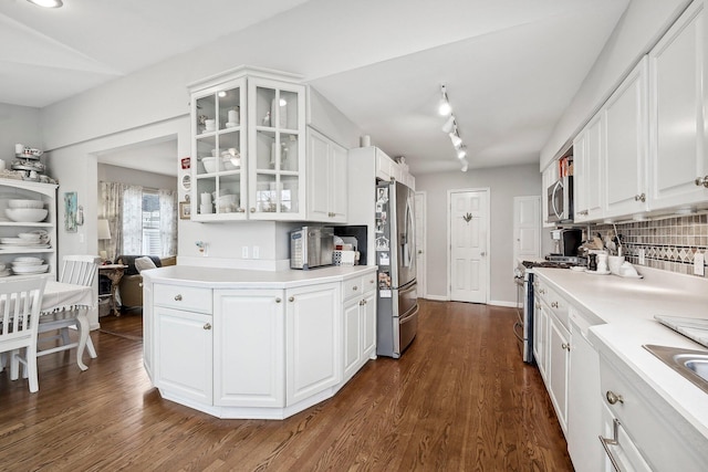 kitchen with white cabinets, dark hardwood / wood-style floors, backsplash, and stainless steel appliances