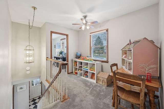 rec room with carpet flooring and ceiling fan with notable chandelier