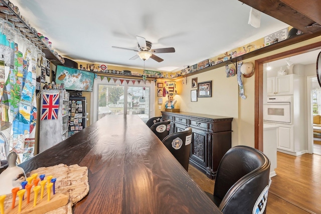 interior space featuring beam ceiling, light hardwood / wood-style floors, and ceiling fan