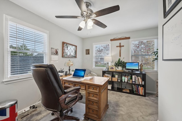 home office featuring light carpet and ceiling fan