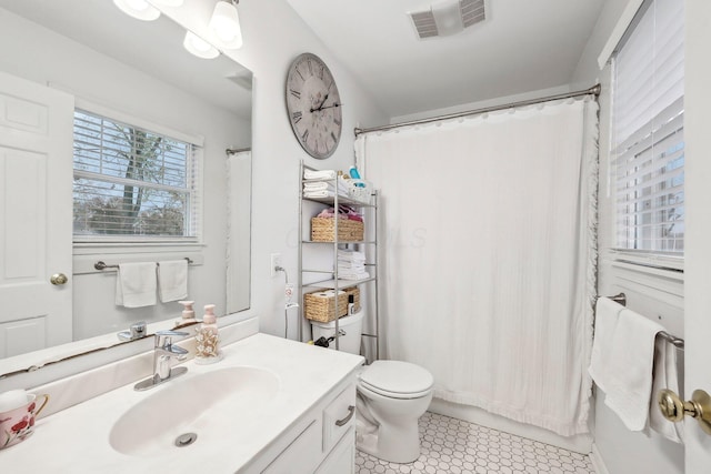 bathroom featuring tile patterned floors, vanity, a shower with shower curtain, and toilet