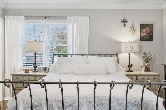 bedroom with hardwood / wood-style floors and ornamental molding