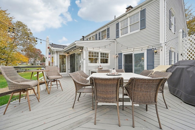 wooden deck with a grill