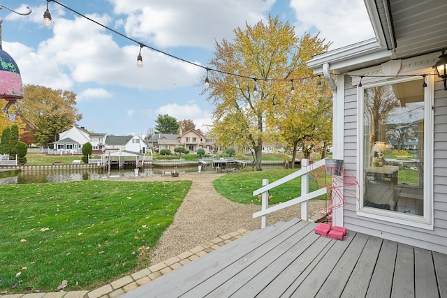 deck featuring a water view and a lawn