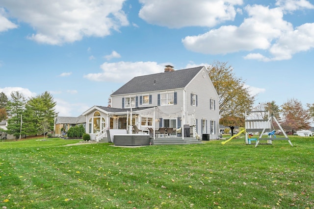 back of house with a wooden deck, outdoor lounge area, cooling unit, a playground, and a lawn