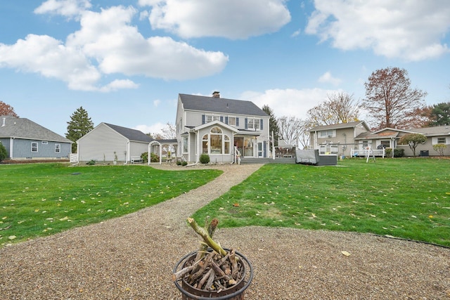 view of front of house with a front lawn and a fire pit