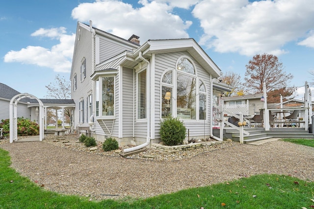 view of side of property with a wooden deck