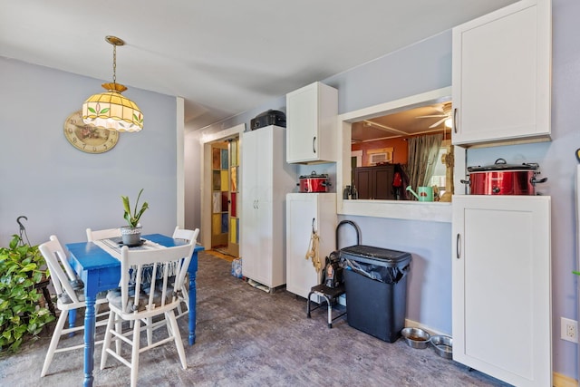 13207 Clapper Hollow Rd, Rockbridge, OH 43149 - dining space featuring ceiling fan and concrete flooring
