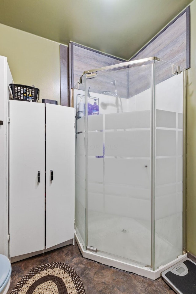 bathroom featuring a shower with shower door