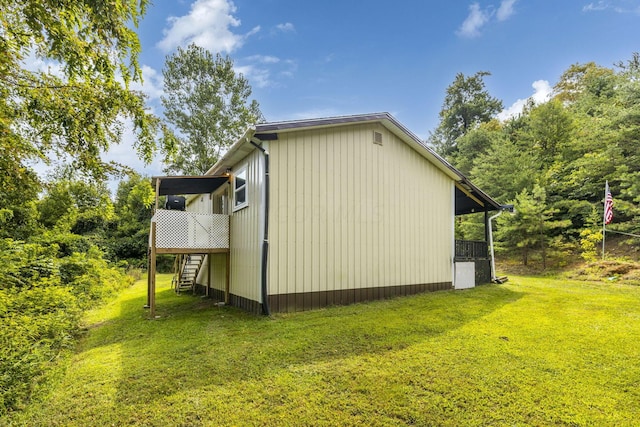 13207 Clapper Hollow Rd, Rockbridge, OH 43149 - view of side of home with stairway, a lawn, and a deck