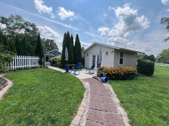 view of yard featuring french doors and a patio