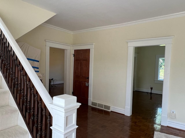 staircase with parquet flooring and crown molding