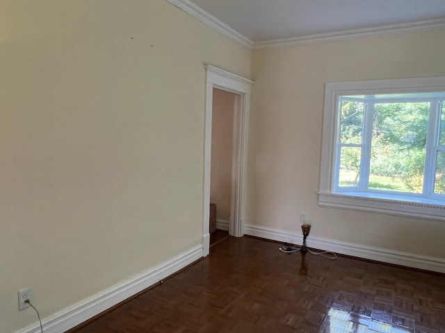 spare room featuring dark parquet floors and ornamental molding