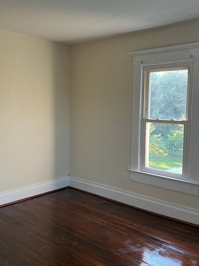 unfurnished room featuring dark hardwood / wood-style flooring