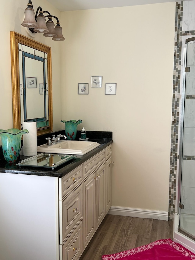 bathroom with hardwood / wood-style floors, vanity, and walk in shower