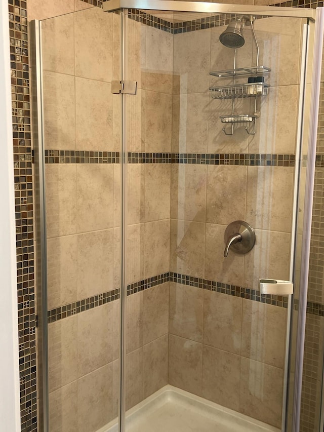 bathroom featuring a shower with door