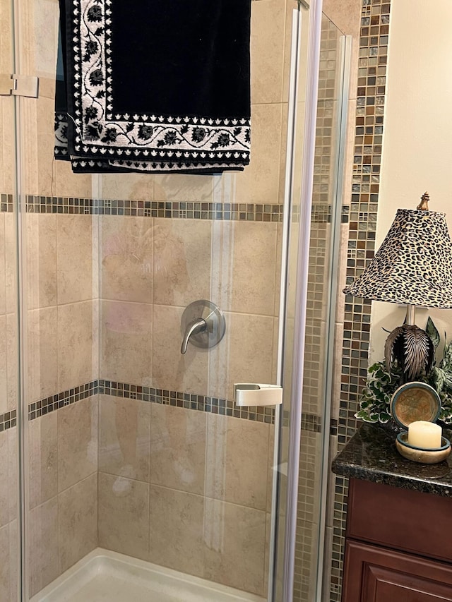 bathroom featuring a shower with shower door