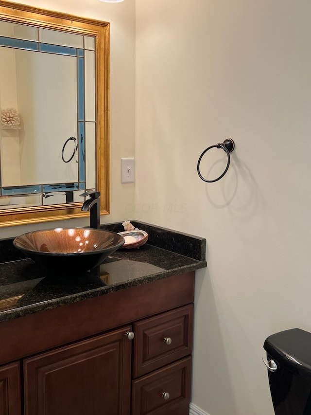 bathroom with vanity and toilet