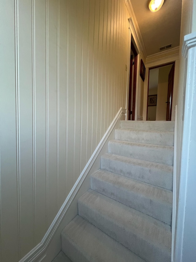 stairs featuring wood walls