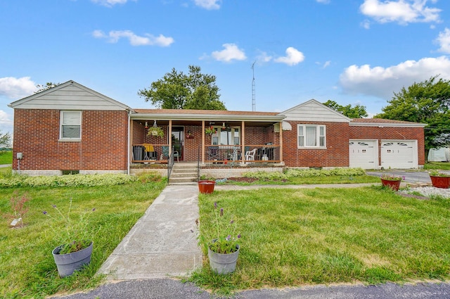 single story home featuring a porch, a garage, and a front lawn