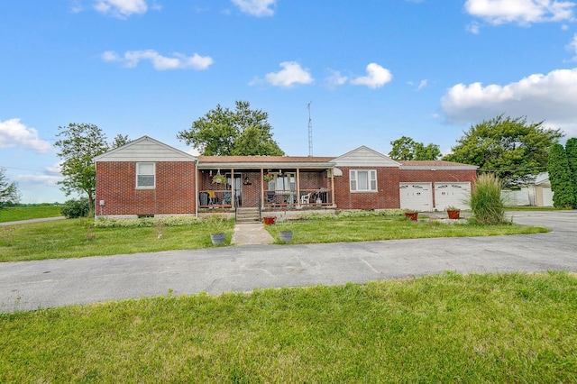 ranch-style home with a porch, a garage, and a front lawn