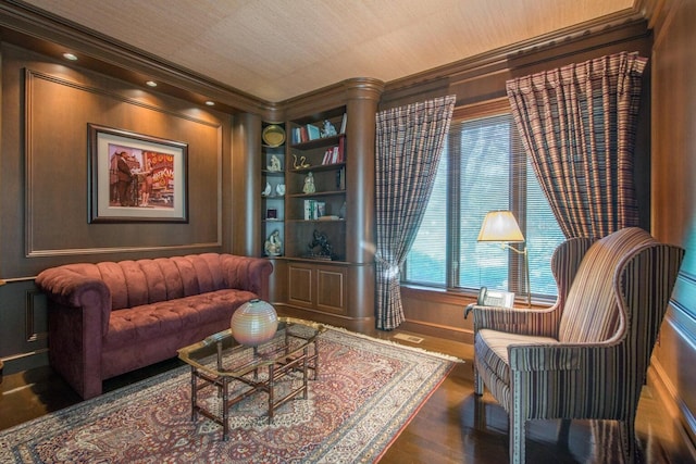 sitting room with dark wood-type flooring and ornamental molding