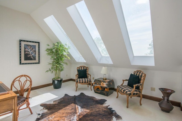 sitting room featuring light carpet and lofted ceiling with skylight