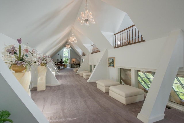 interior space with carpet floors, high vaulted ceiling, and an inviting chandelier