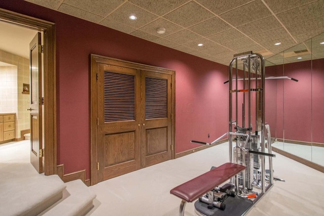 interior space with carpet flooring and a paneled ceiling