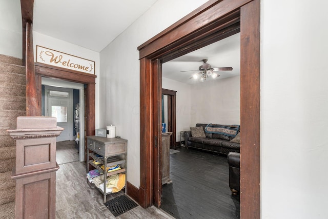 corridor with hardwood / wood-style floors