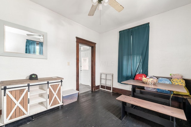 interior space featuring ceiling fan, breakfast area, and dark wood-type flooring