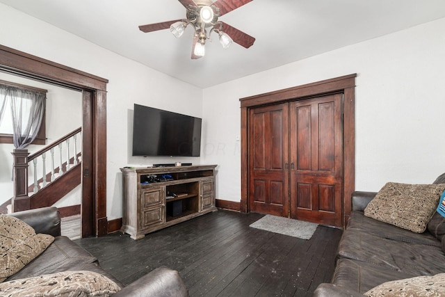 living room with dark hardwood / wood-style floors and ceiling fan