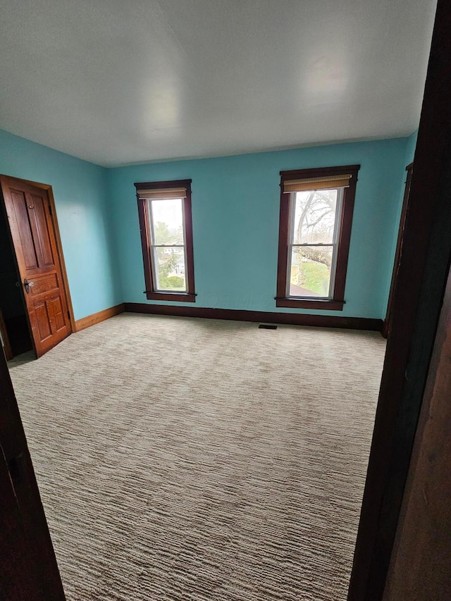 empty room with light colored carpet