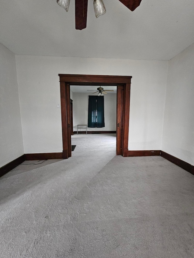 carpeted empty room with ceiling fan