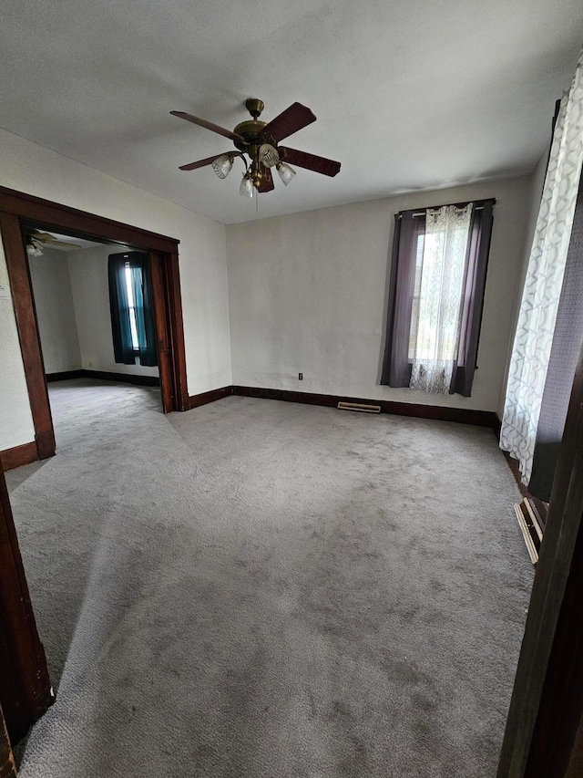 unfurnished room featuring carpet and ceiling fan