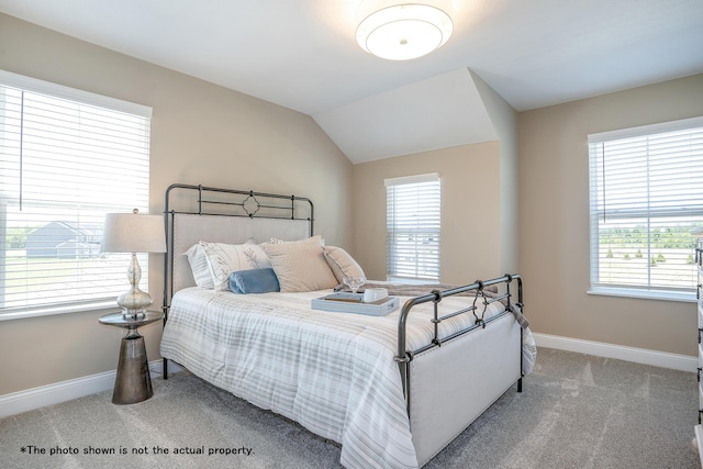 carpeted bedroom featuring vaulted ceiling