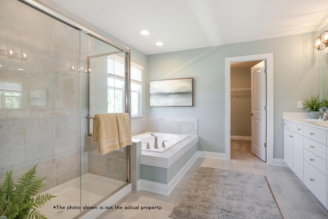 bathroom featuring tile patterned flooring, vanity, and separate shower and tub