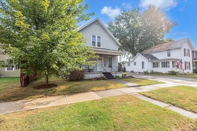 view of front of property featuring covered porch and a front lawn