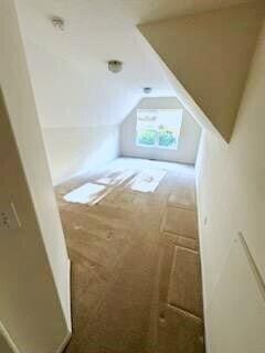 bonus room featuring lofted ceiling