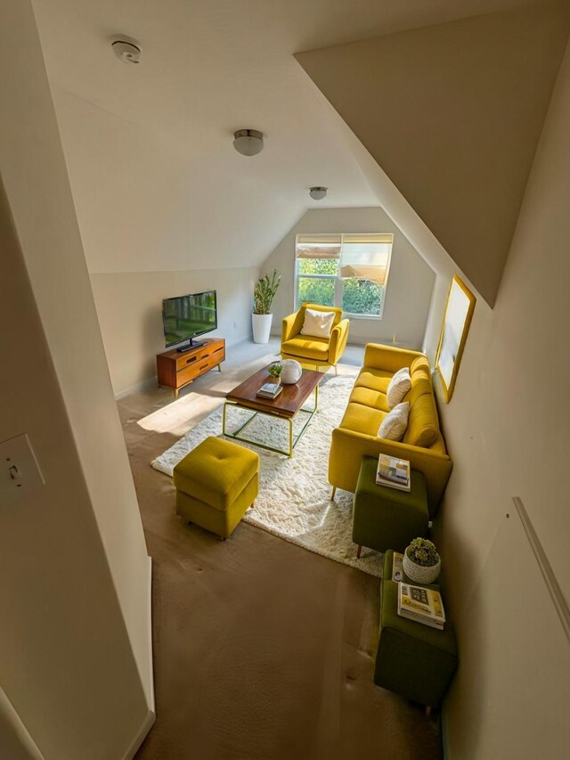 living room featuring vaulted ceiling and carpet flooring