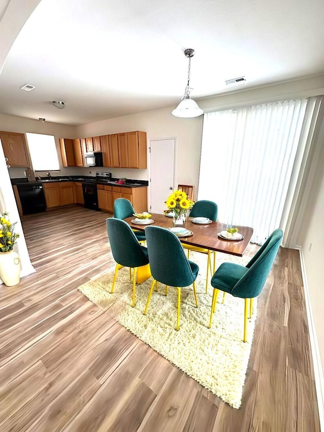 dining area with light wood-type flooring